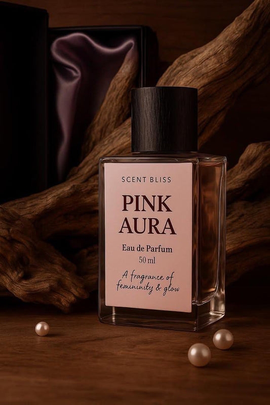 Perfume bottle labeled 'Pink Aura by ScentBliss' with decorative elements on a wooden background